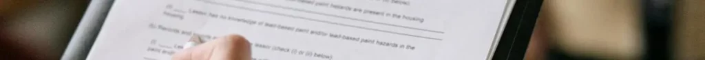 A hand signing a contract. Legal notice.